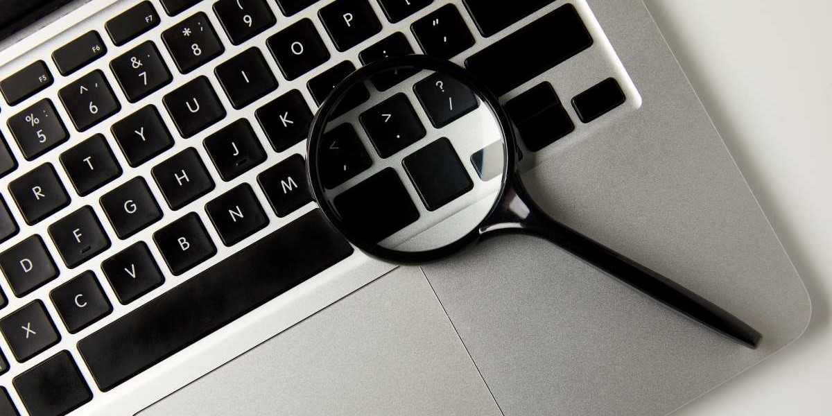 top view of magnifying glass and laptop